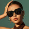 Oversized black sunglasses with an angular cat-eye design